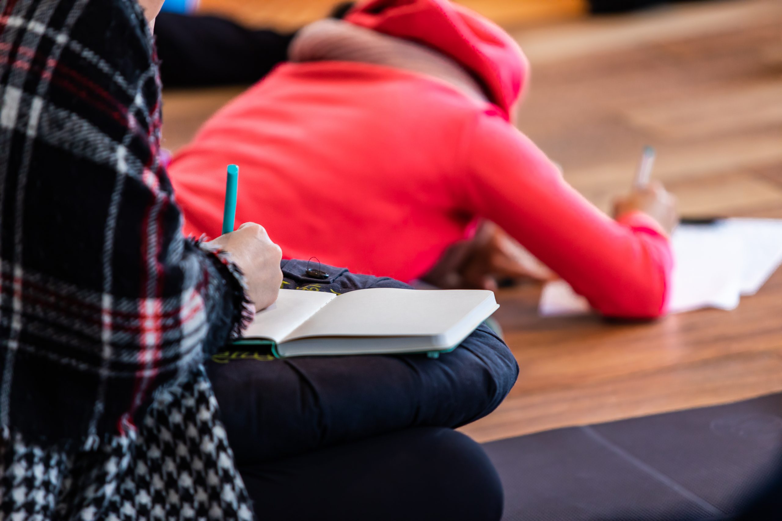 Two students writing notes